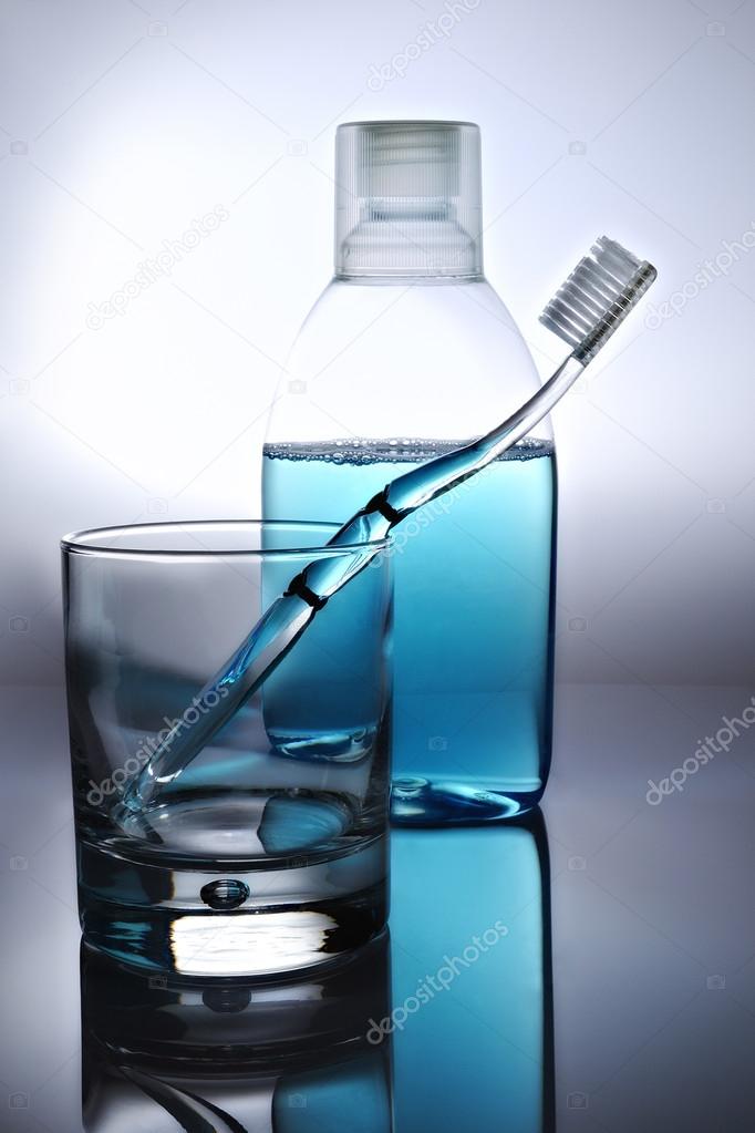 toothbrush, mouthwash and glass