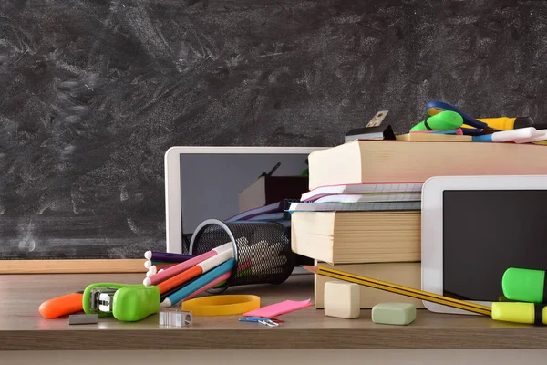 School Supplies Electronic Gadgets Teaching Wooden Desk Chalk Blackboard Background — Stockfoto