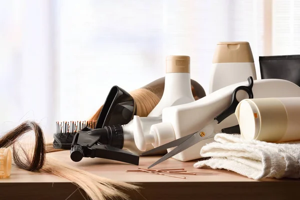 Background with hair care products on wooden table and window background. Front view. Horizontal composition.