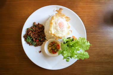 stir-fried pork, stir-fried pork with holy basil and chili and sunny side up egg