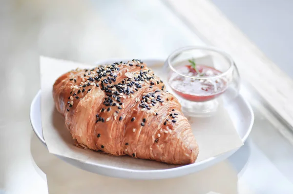 croissant , French croissant or French bread with sesame topping and  strawberry dressing