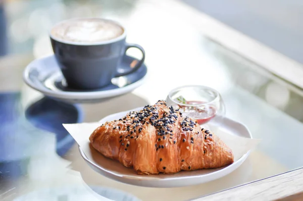 croissant , French croissant or French bread with sesame topping and hot coffee