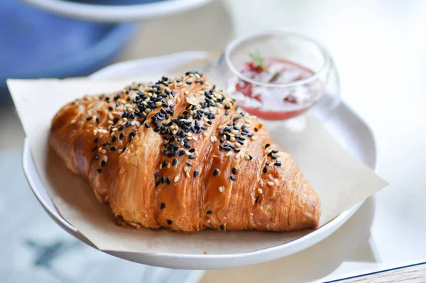 croissant , French croissant or French bread with sesame topping and  strawberry dressing