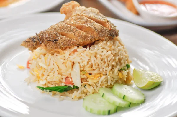 stir fried rice or fried rice with fried fish topping and sauce, fish and rice
