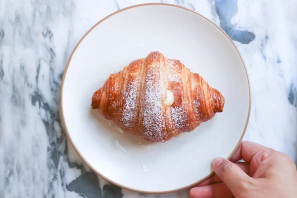croissant , French croissant or French bread or custard croissant with powered sugar or icing sugar topping