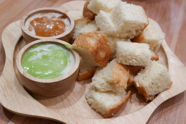 bread or steamed bread with pandanus custard and milk tea custard or toast with dip for serve