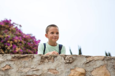 Family spending time together, cheerful parent with kids walking in the park in good weather