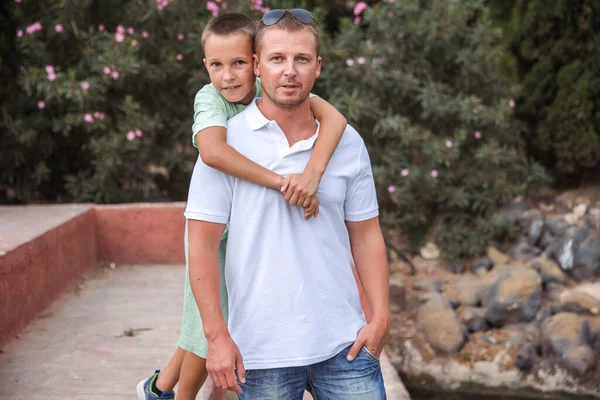 Father and son walk in the city park, the concept of family rest and healthy rest of life
