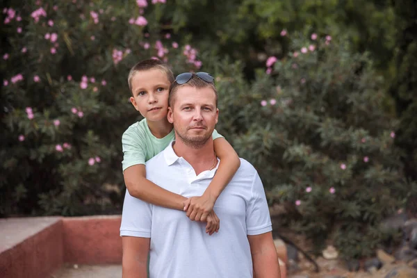 Father and son walk in the city park, the concept of family rest and healthy rest of life