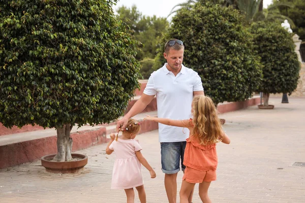 Father and son walk in the city park, the concept of family rest and healthy rest of life