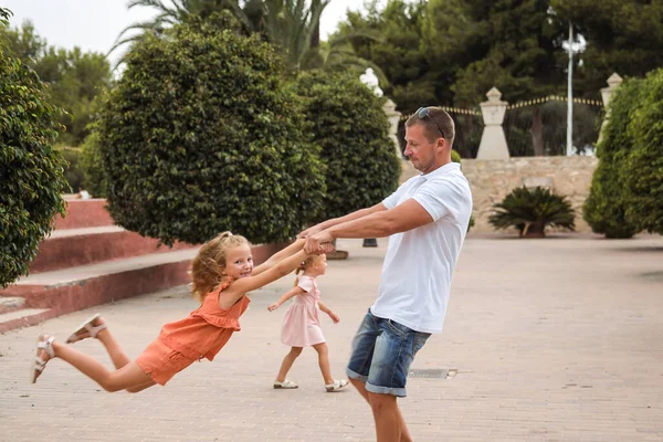 Father and son walk in the city park, the concept of family rest and healthy rest of life