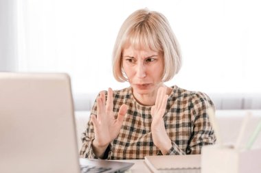 Business Woman listening educational lecture on computer, watching webinar, studying on online courses, writing notes in paper copybook, e-learning concept