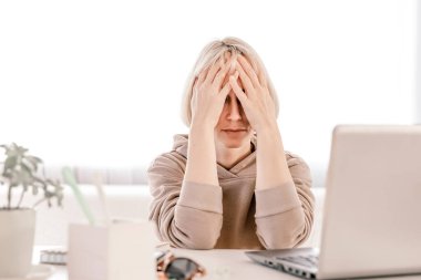 Business Woman listening educational lecture on computer, watching webinar, studying on online courses, writing notes in paper copybook, e-learning concept