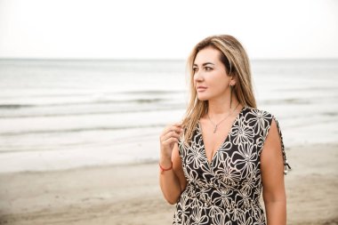 Portrait of a woman on the beach, ocean, unity with nature, healthy lifestyle
