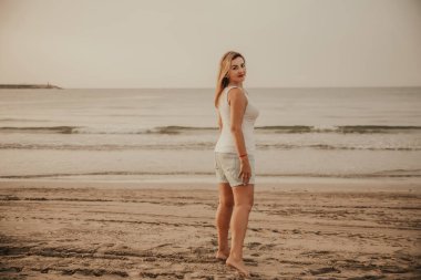 Portrait of a woman on the beach, ocean, unity with nature, healthy lifestyle