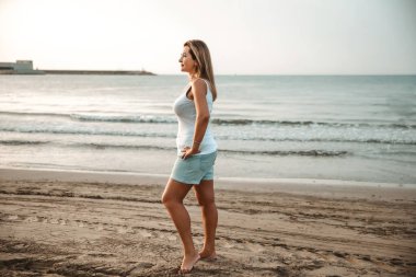Portrait of a woman on the beach, ocean, unity with nature, healthy lifestyle