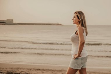 Portrait of a woman on the beach, ocean, unity with nature, healthy lifestyle