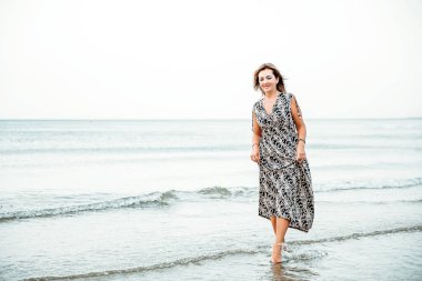 Portrait of a woman on the beach, ocean, unity with nature, healthy lifestyle