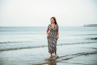 Portrait of a woman on the beach, ocean, unity with nature, healthy lifestyle