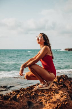Portrait of a woman on the beach, ocean, unity with nature, healthy lifestyle