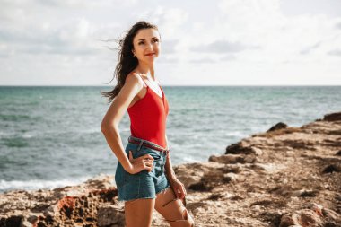 Portrait of a woman on the beach, ocean, unity with nature, healthy lifestyle