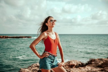 Portrait of a woman on the beach, ocean, unity with nature, healthy lifestyle
