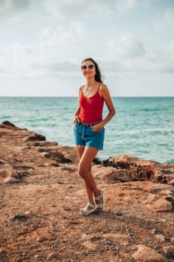 Portrait of a woman on the beach, ocean, unity with nature, healthy lifestyle
