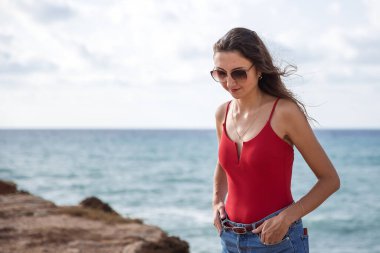 Portrait of a woman on the beach, ocean, unity with nature, healthy lifestyle