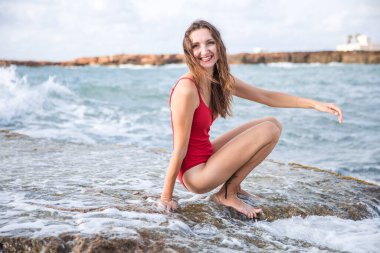 Portrait of a woman on the beach, ocean, unity with nature, healthy lifestyle