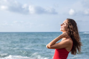 Portrait of a woman on the beach, ocean, unity with nature, healthy lifestyle