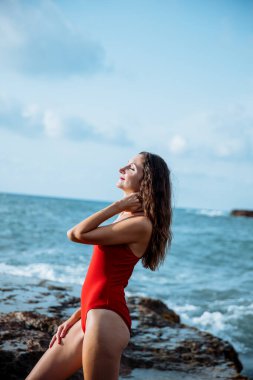 Portrait of a woman on the beach, ocean, unity with nature, healthy lifestyle