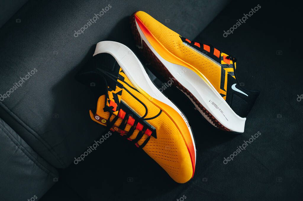 PARIS, FRANCE, MAY 3. 2022: Nike running shoes Pegasus 38 in yellow, black, red and orange colors. Shoes with Zoom X Foam