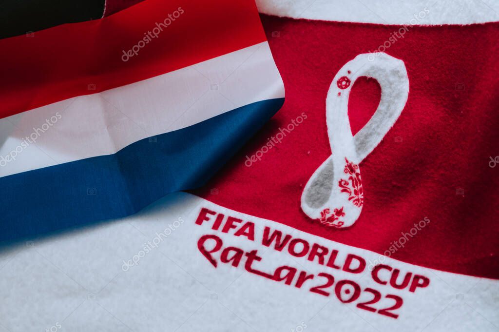 QATAR, DOHA, 18 JULY, 2022: Netherlands National flag and logo of FIFA World Cup in Qatar 2022 on red carpet. Soccer sport background, edit space. Qatar 22 Wallpaper. National symbol, football event