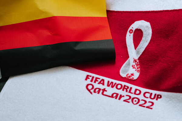 QATAR, DOHA, 18 JULY, 2022: Germany National flag and logo of FIFA World Cup in Qatar 2022 on red carpet. Soccer sport background, edit space. Qatar 22 Wallpaper. National symbol, football event