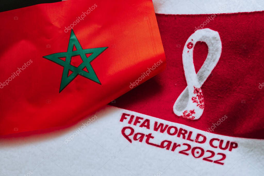 QATAR, DOHA, 18 JULY, 2022: Morocco National flag and logo of FIFA World Cup in Qatar 2022 on red carpet. Soccer sport background, edit space. Qatar 22 Wallpaper. National symbol, football event
