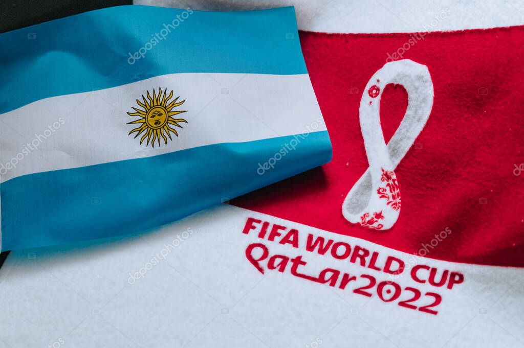 QATAR, DOHA, 18 JULY, 2022: Argentina National flag and logo of FIFA World Cup in Qatar 2022 on red carpet. Soccer sport background, edit space. Qatar 22 Wallpaper. National symbol, football event
