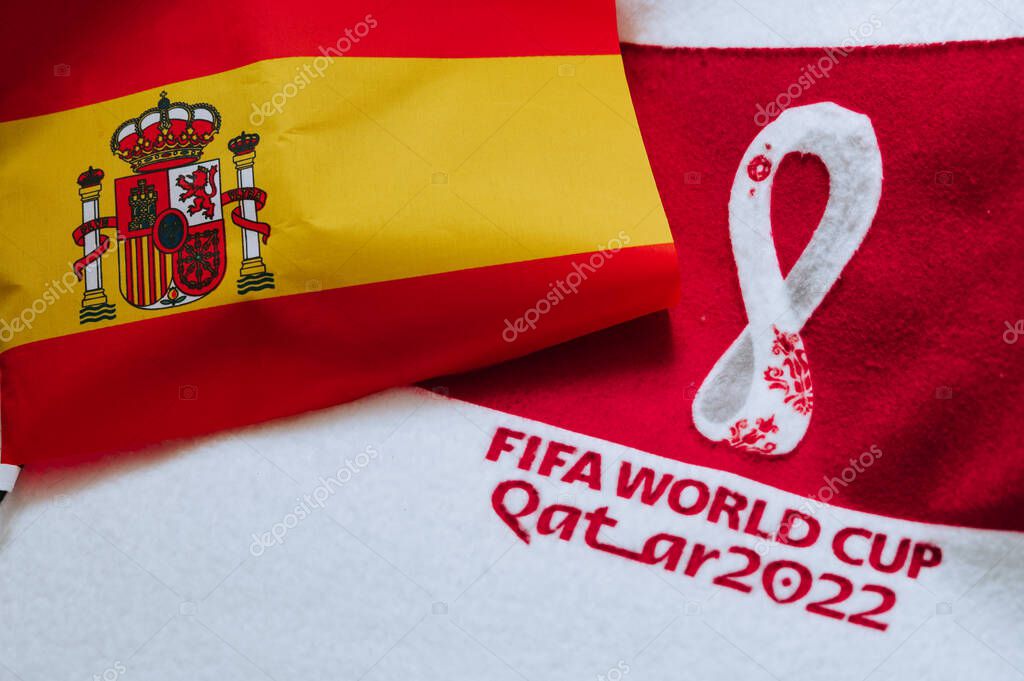 QATAR, DOHA, 18 JULY, 2022: Spain National flag and logo of FIFA World Cup in Qatar 2022 on red carpet. Soccer sport background, edit space. Qatar 22 Wallpaper. National symbol, football event