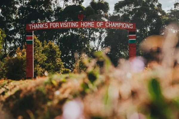 Thanks for Visiting Home of Champions. Gate at the entrance to the city of Iten, in East Africa. A city in Kenya where the world\'s elite endurance runners live and train. A place for marathon training