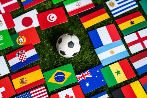 Football Ball and Flags of all 32 Countries which will play in Qatar. Soccer wallpaper