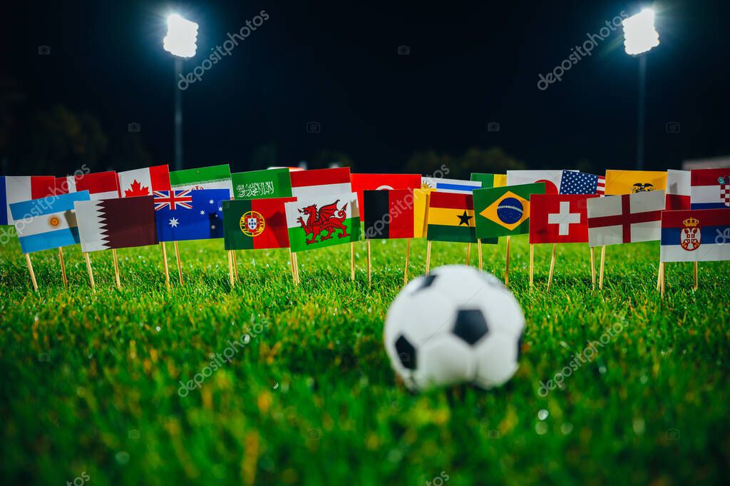 DOHA, QATAR - MAY, 24, 2022: All nations flag of FIFA Football World Cup 2022 in Qatar. Fans support concept photo. Black edit space