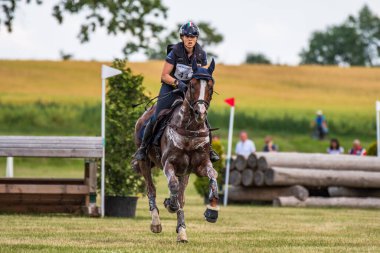 Strzegom Horse Trials, Morawa, Poland - June, 25, 2022: Italian Sabrina Assirelli on horse Strategik Wing, on the Cross Country route during the competition.