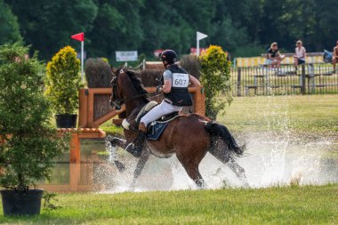 Strzegom Horse Trials, Morawa, Poland - June, 25, 2022: Spanish Esteban Benitez Valle on horse Escara GP, on the Cross Country route during the competition.