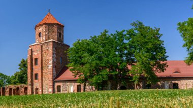 Castle in Toszek, a brick castle from the 15th century, partially reconstructed. View from the green courtyard to the building.