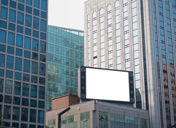 Big blank white screen  television for advertising on modern buildings in the city with blue sky background, useful for promotion marketing of your products or services