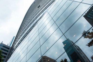 Pencere camı ön cephesi olan modern ofis binası arka plan için soyut kalıp kullanımı, düşük açı görünümü