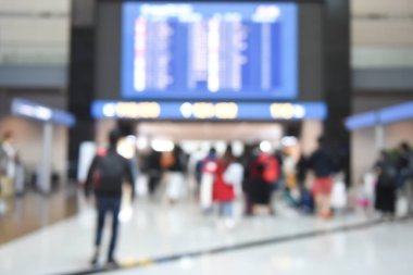 Blurred of crowd people, passengers looking at airport flight schedule interior international airport terminal and walking to the gate can be used for business background, perspective view