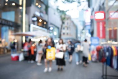 Blurred crowd young asian people, travelers wlking, shopping at street market, outdoor shopping center in the city in the evening, Seoul, Korea