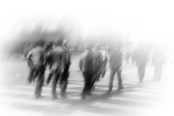 Abstract blurred background, group asian business people walking cross the road on zebra crossing in the city business area, can be used for business background, black and white