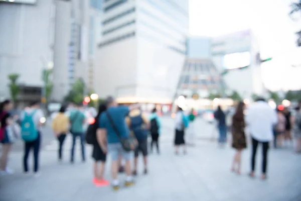 Blurred background of people crowd, travelers walking on footpath in front of department store, shopping center in the city, Seoul, Korea, urban scene