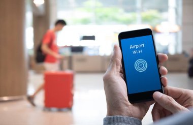 Man using mobile smart mobile phone connecting airport free wifi, wireless network communication, high speed internet airport service